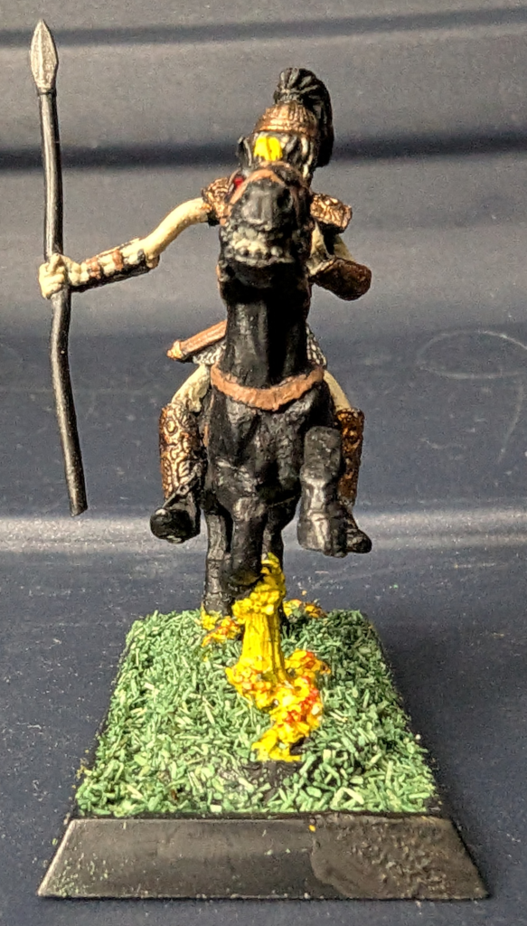 Front view of an armored skeleton riding a flaming black horse. The skeleton holds a spear in its right hand.